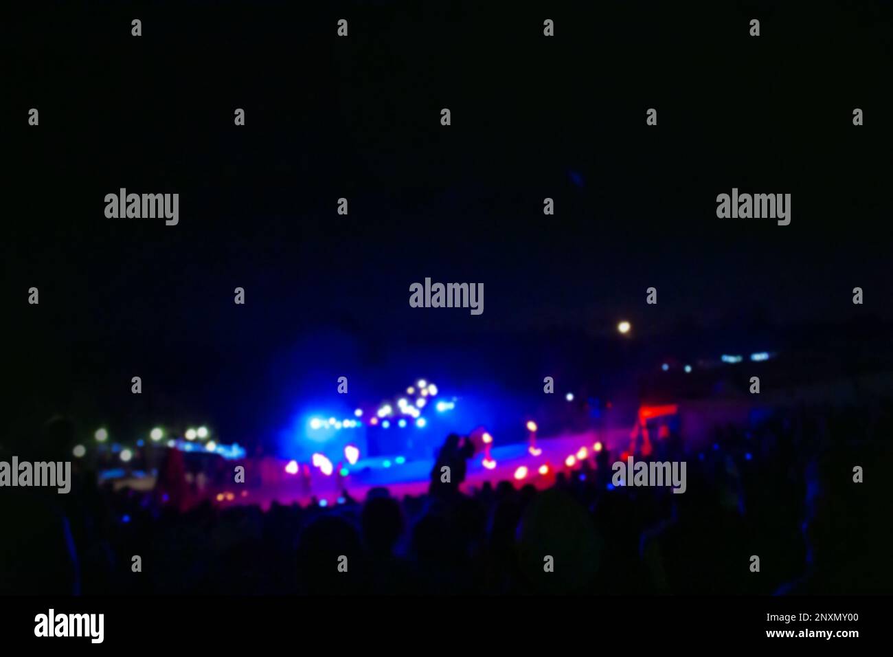 Street music concert in the park at night. People at outdoor concert event in the garden. Stock Photo