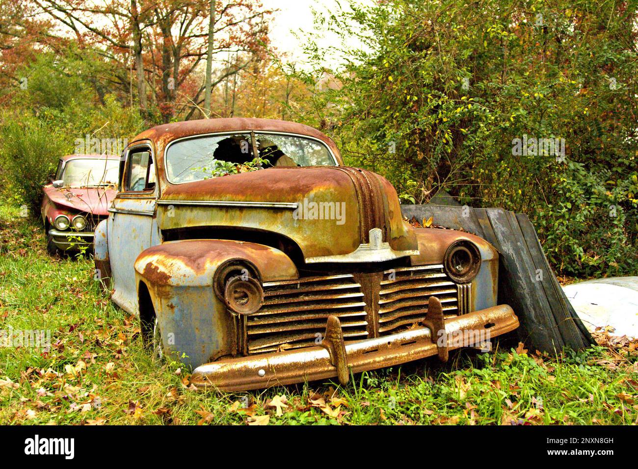Old classic American car in a scrap yard Stock Photo Alamy