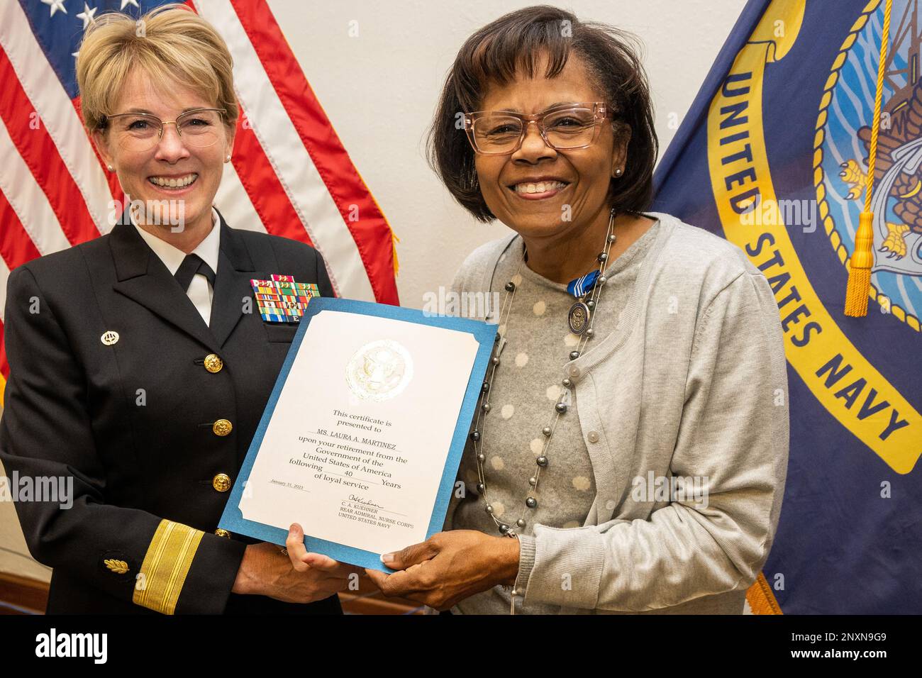 Rear Adm. Cynthia Kuehner, commander of Naval Medical Forces Support Command (NMFSC) presents Laura Martinez, NMFSC N7 Education and Training Directorate with the Superior Civilian Service Award signed by the Navy Surgeon General.  Martinez was the first African Amercan to serve as Force Master Chief and Director of the Medical Corps,  and only the second female to hold the prestigous office. Stock Photo