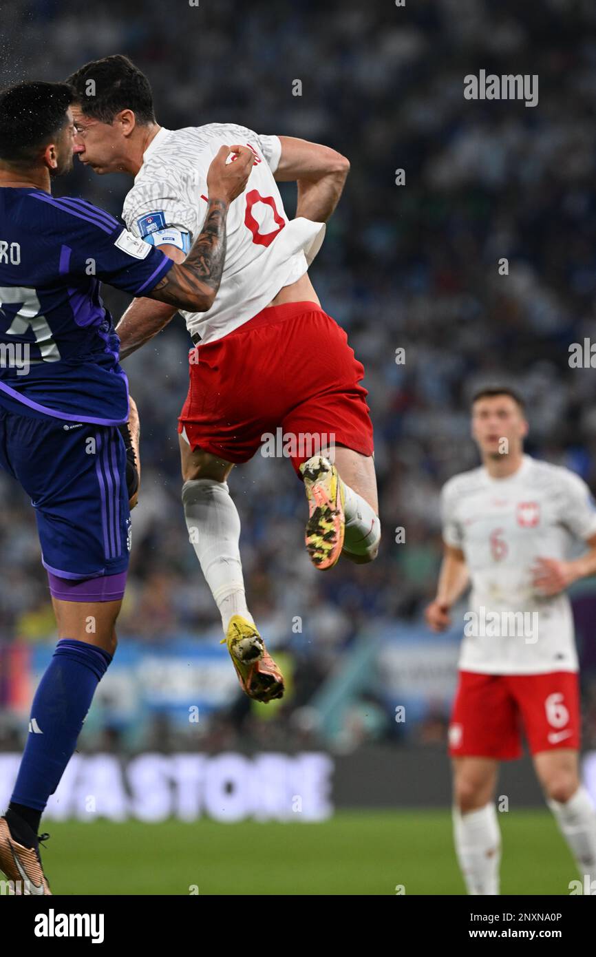 Poland's Robert Lewandowski duels Argentina's Cristian Romero for a header in Argentina's 2-0 group stage victory in the 2022 FIFA World Cup in Qatar. Stock Photo