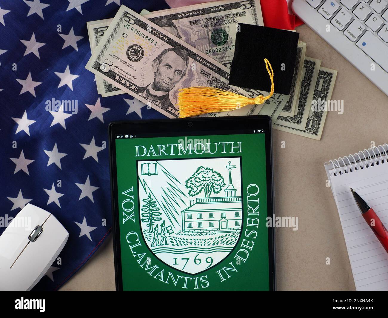 In this photo illustration, Dartmouth College  logo seen displayed on a tablet. Stock Photo