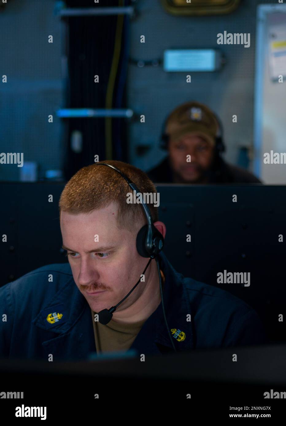 230216-N-WM182-1011 SOUTH CHINA SEA (Feb. 16, 2023) U.S. Navy Chief Machinist’s Mate Devin Stumpf, from Teaneck, N.J., stands watch in the Tactical Flag Communication Center aboard the aircraft carrier USS Nimitz (CVN 68). Nimitz is in U.S. 7th Fleet conducting routine operations. 7th Fleet is the U.S. Navy's largest forward-deployed numbered fleet, and routinely interacts and operates with Allies and partners in preserving a free and open Indo-Pacific region. Stock Photo