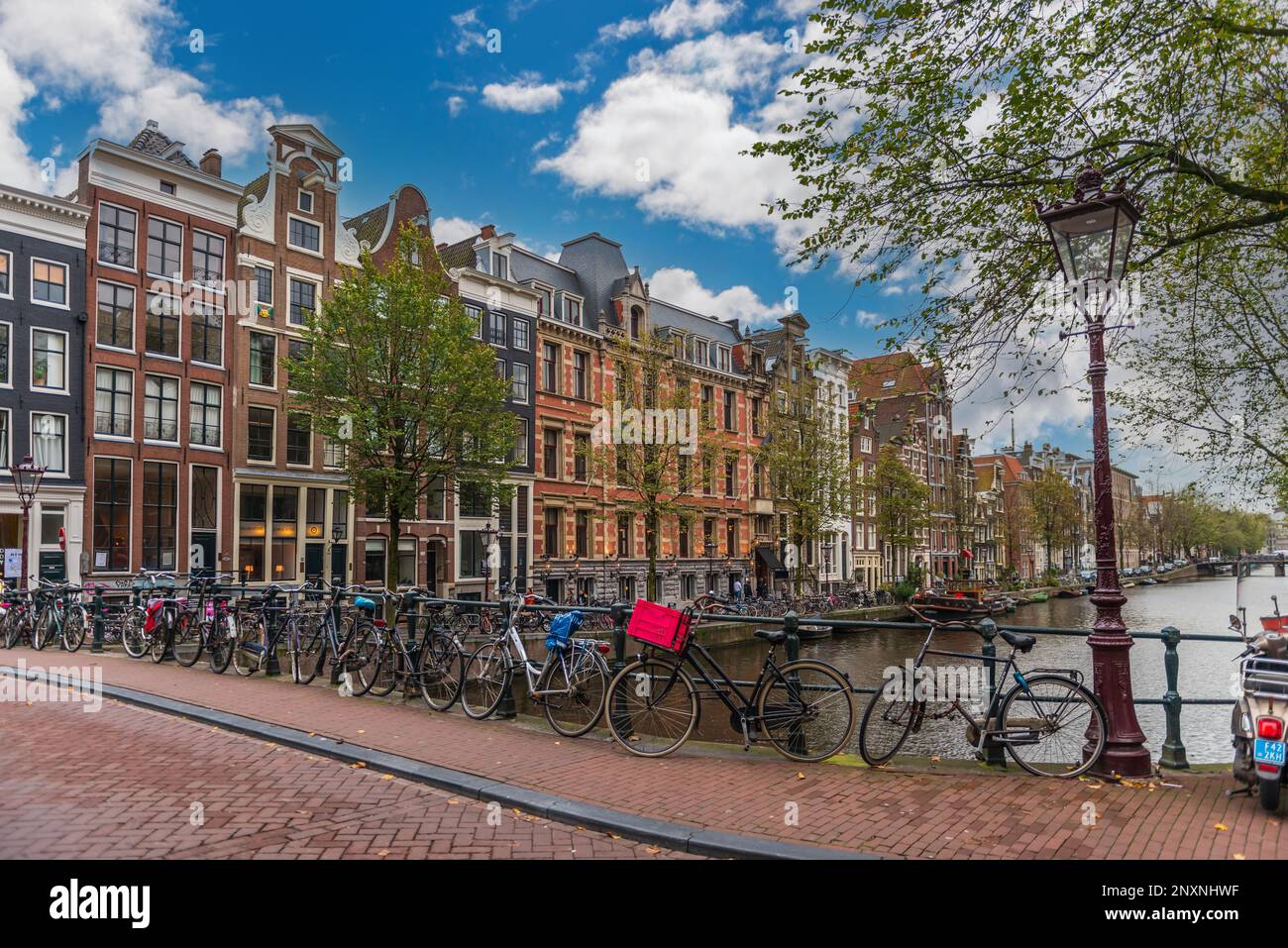 Typical Dutch facade along the canals, with many bicycles, in Amsterdam, Holland, Netherlands Stock Photo
