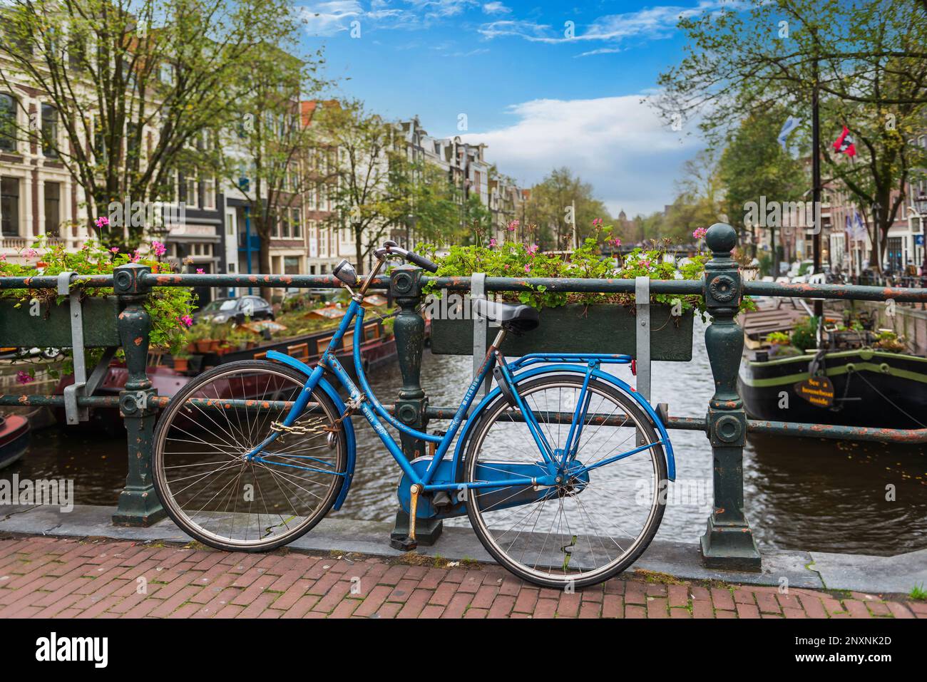 Bicycle on a bridge spanning a canal in Amsterdam in Holland in the Netherlands Stock Photo