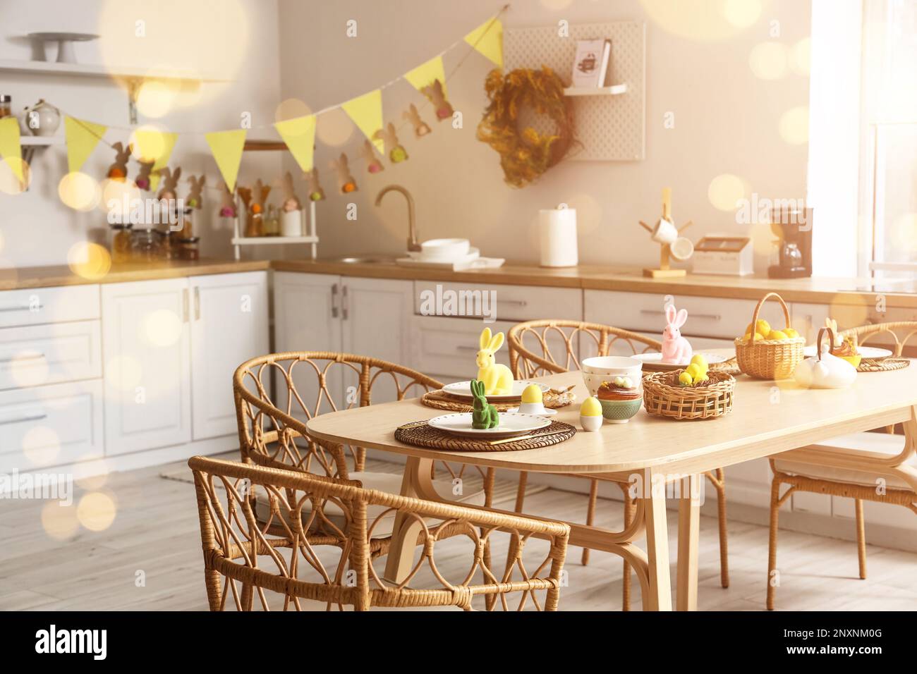 Festive table setting for Easter dinner in kitchen Stock Photo