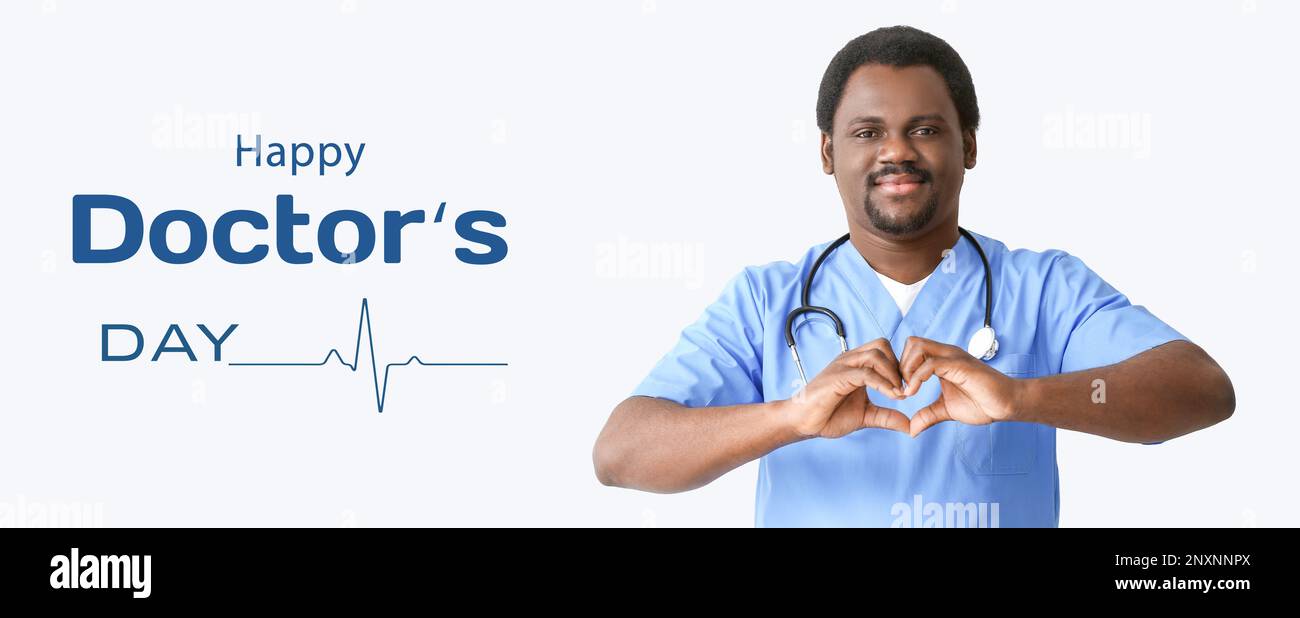 Male African-American nurse making heart with his hands on light ...