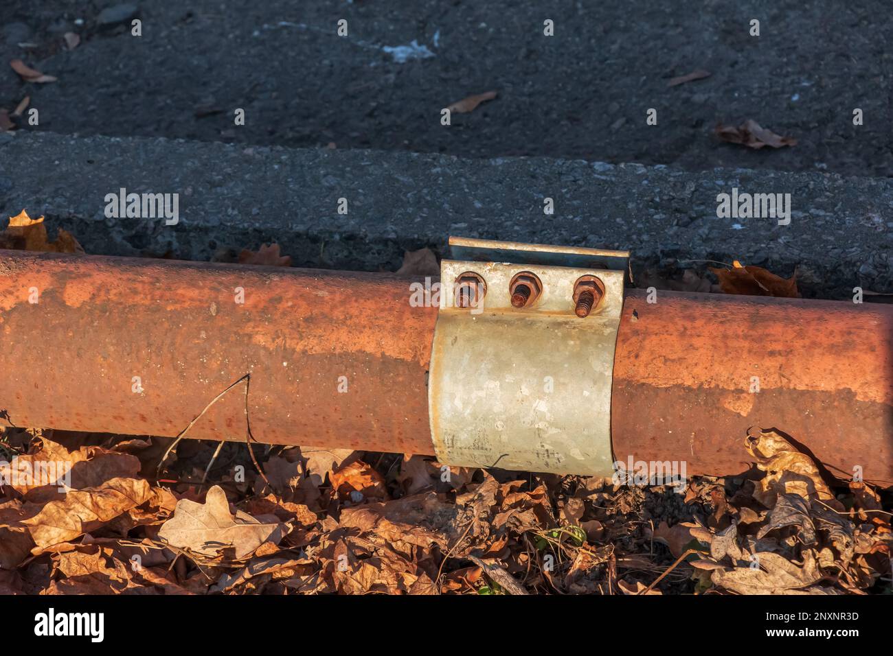 Old rusty pipe for hot water supply. Clamp for removing water leaks