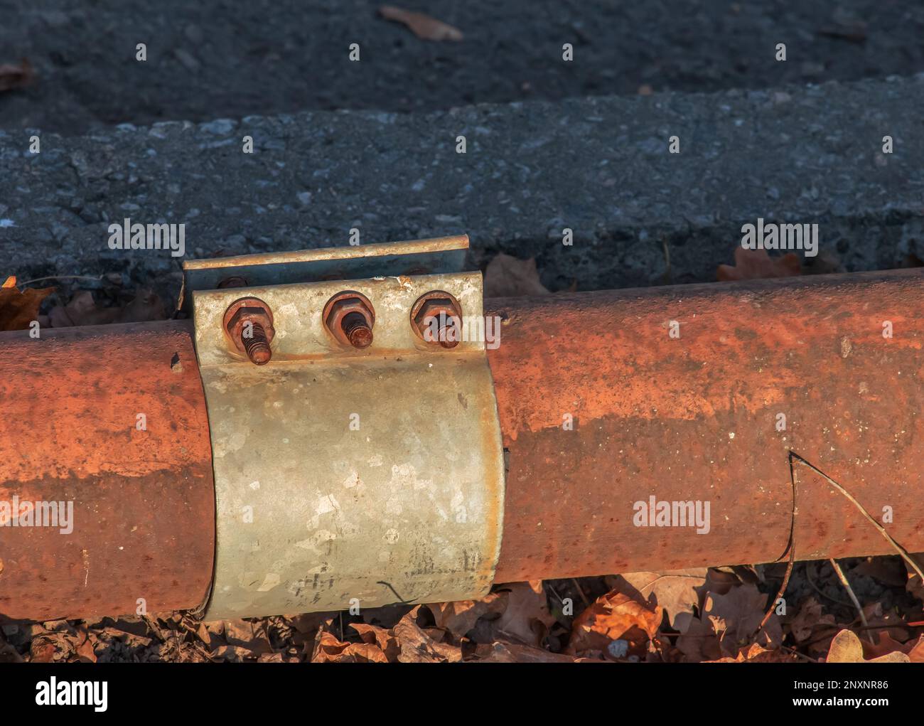 Old rusty pipe for hot water supply. Clamp for removing water leaks