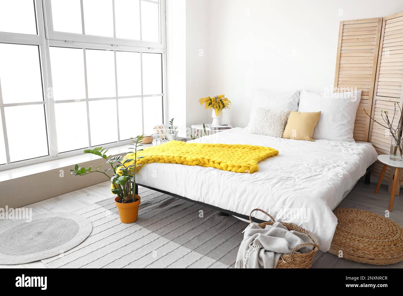 Interior of modern bedroom with mimosa flowers in vase and window Stock ...