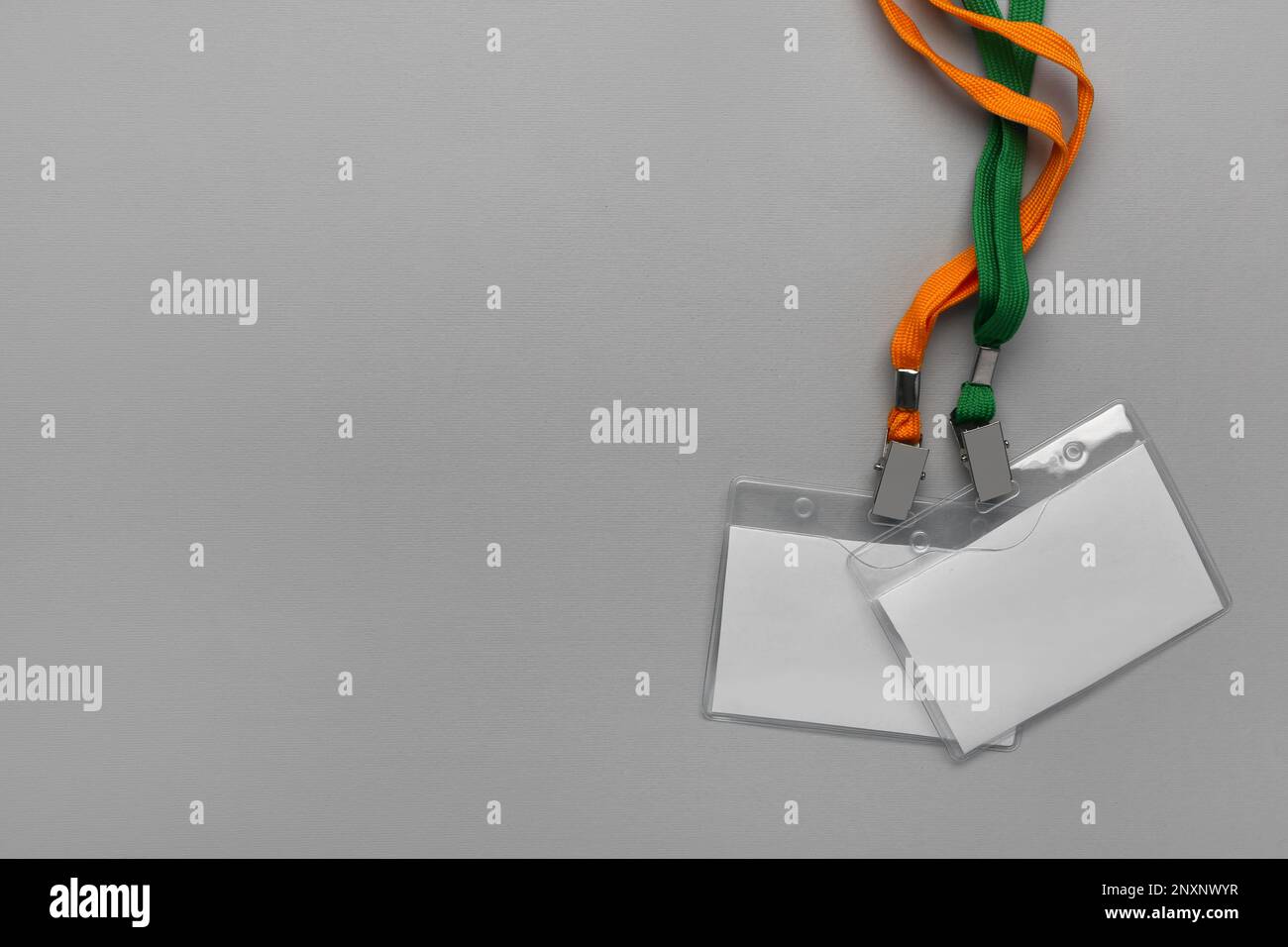 Blank badges with neck lanyard on grey background Stock Photo - Alamy