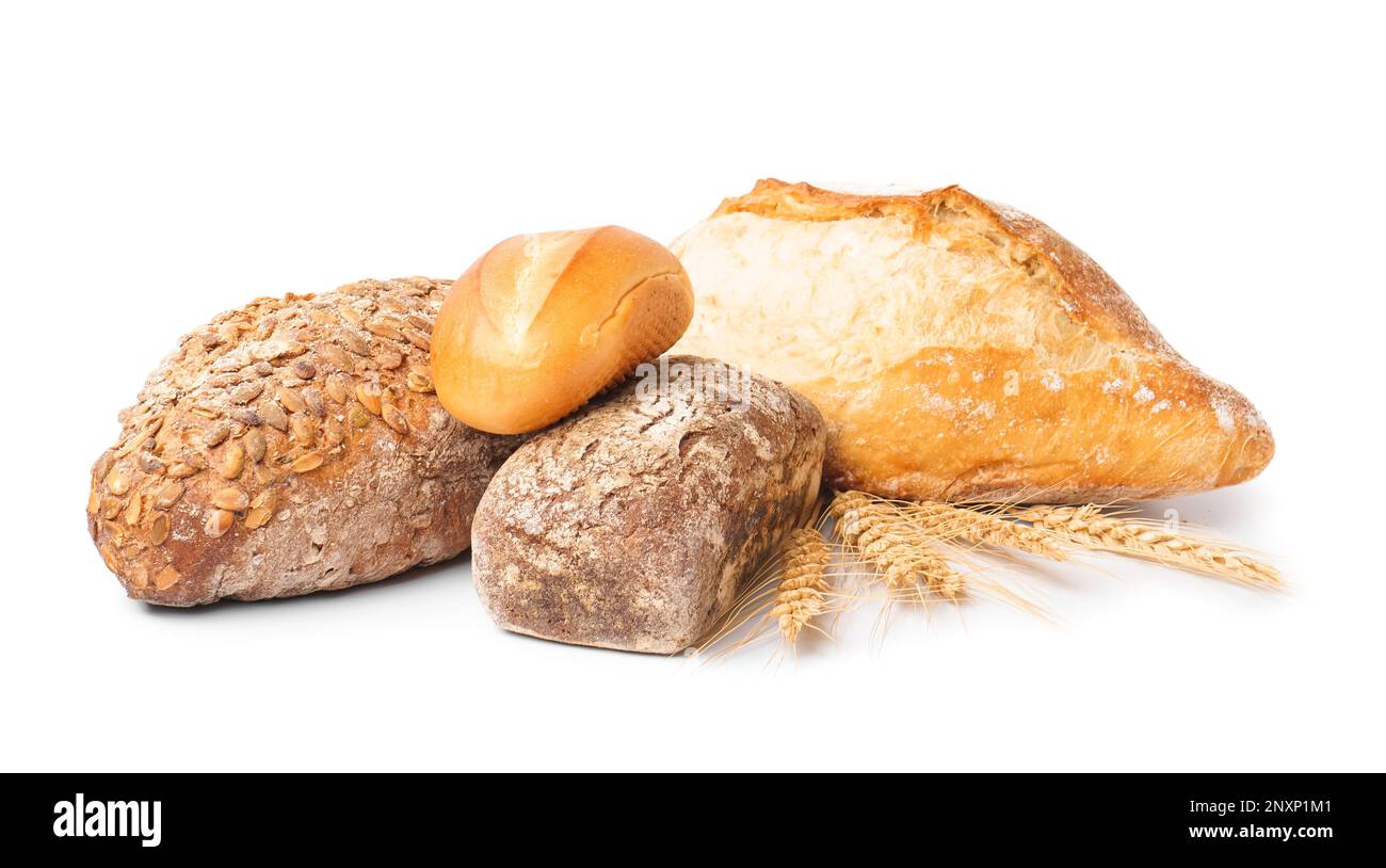 Loaves of different bread and wheat ears isolated on white background ...