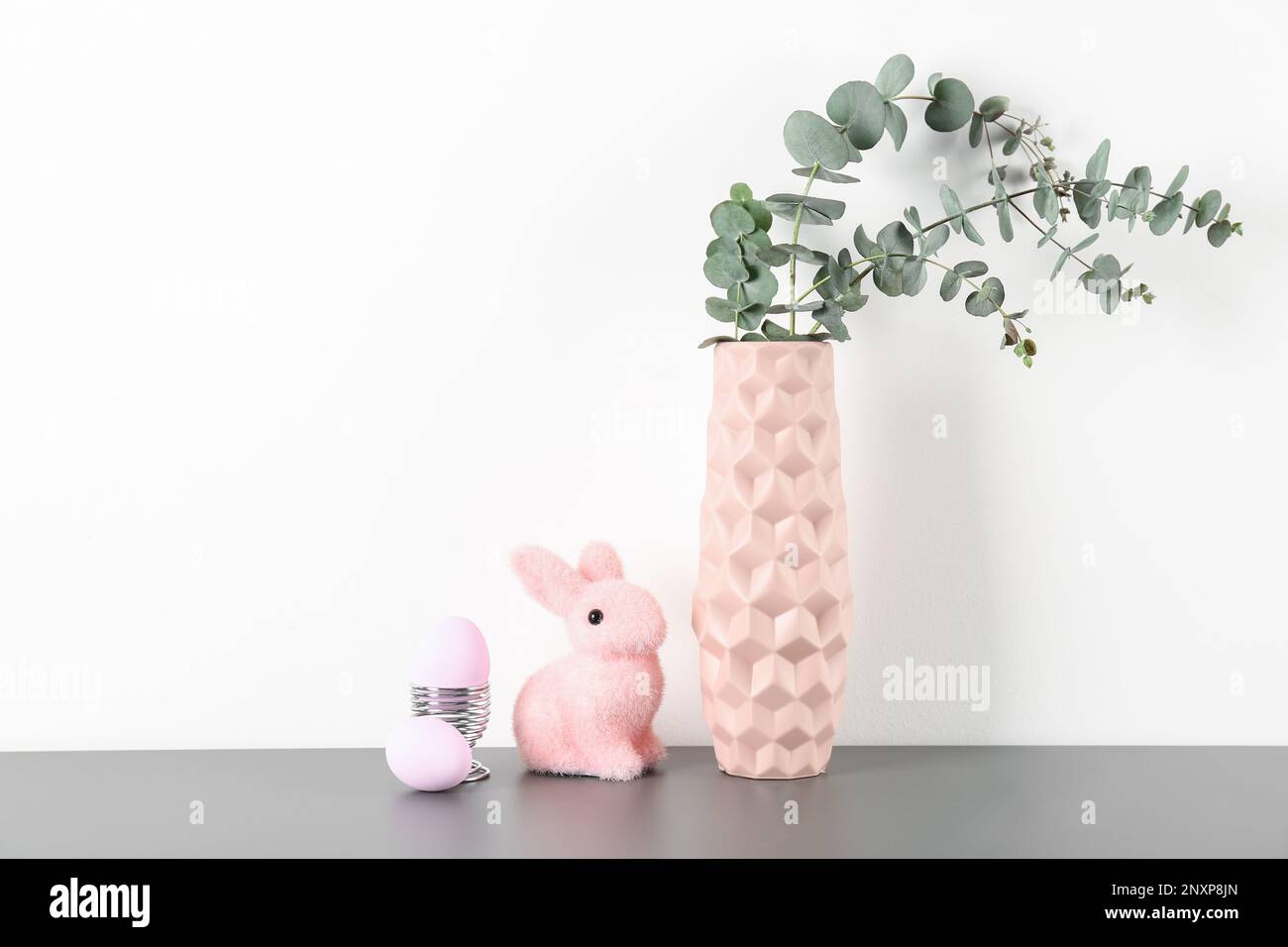 Vase with eucalyptus branches, Easter eggs and bunny on white ...