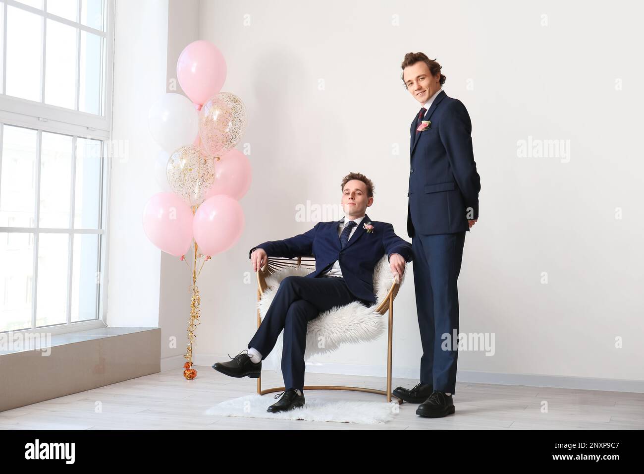 Teenage boys dressed for prom in room Stock Photo