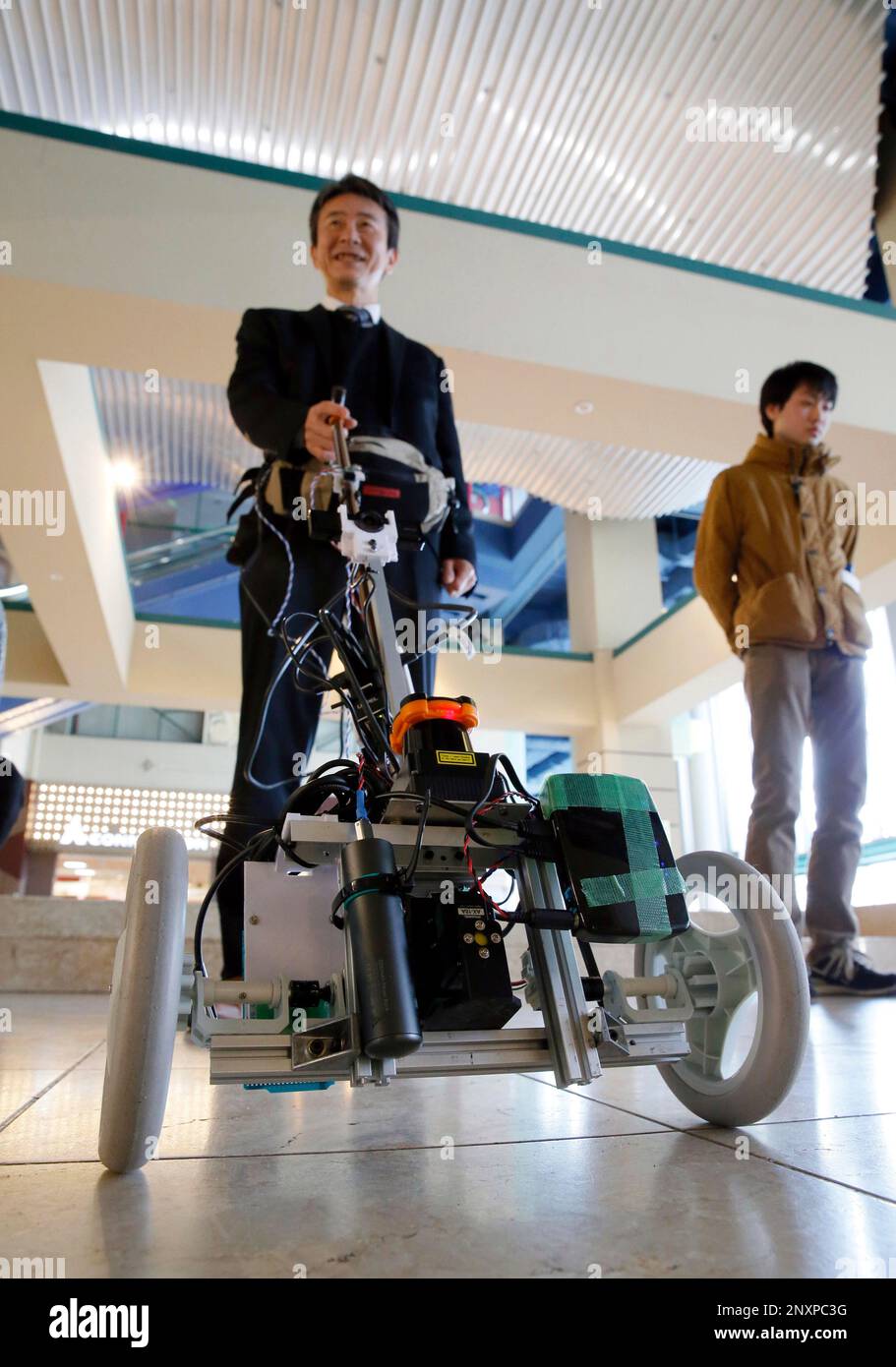 A group of Osaka City University unveiled a cane shaped robot to lead ...