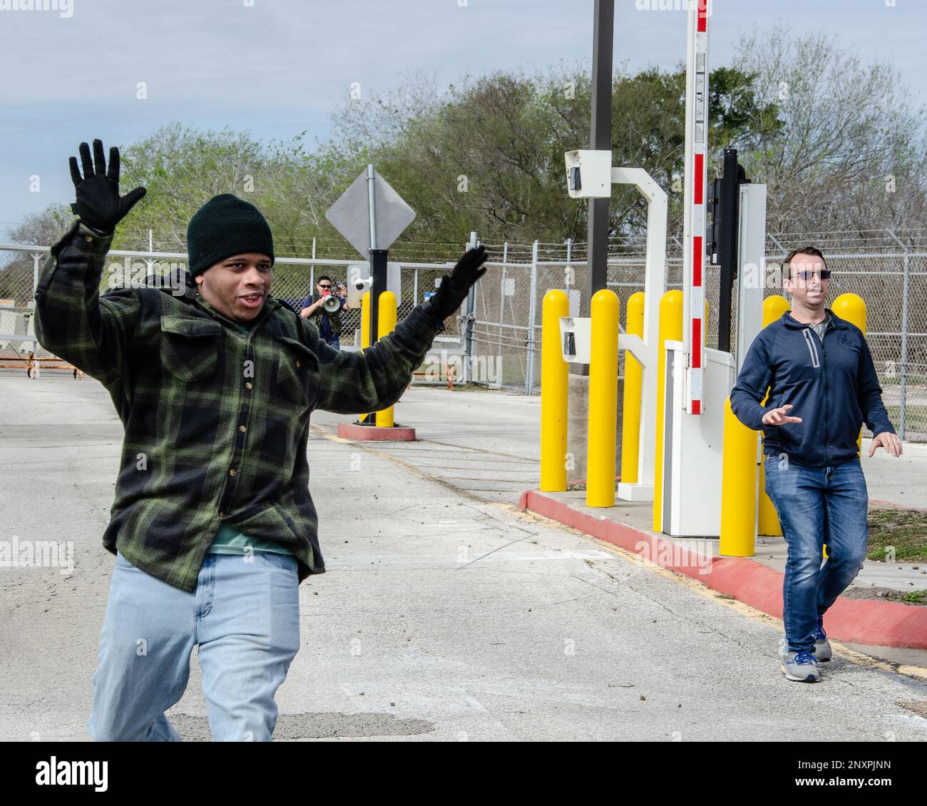 Simulated protestors charge the Naval Air Station Kingsville back gate but stopp as security personnel deploy weapons and order them to stop.  The training exercise was part of Exercise Citadel Shield-Solid Curtain 2023, designed to test the readiness of Navy security forces. Stock Photo
