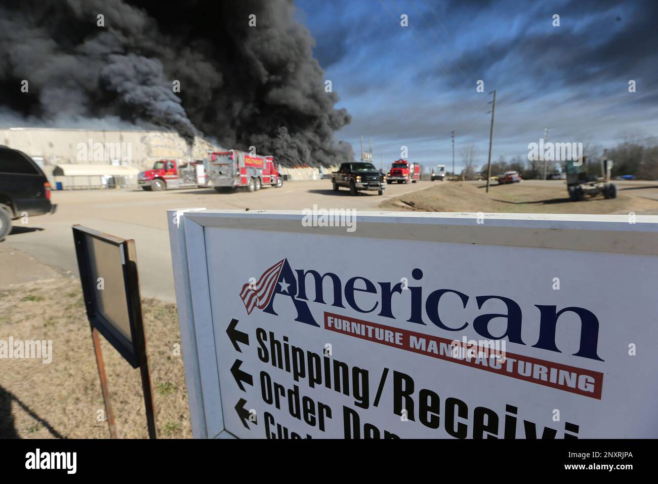 Heavy black smoke fills the air as fire crews begin to assemble at the