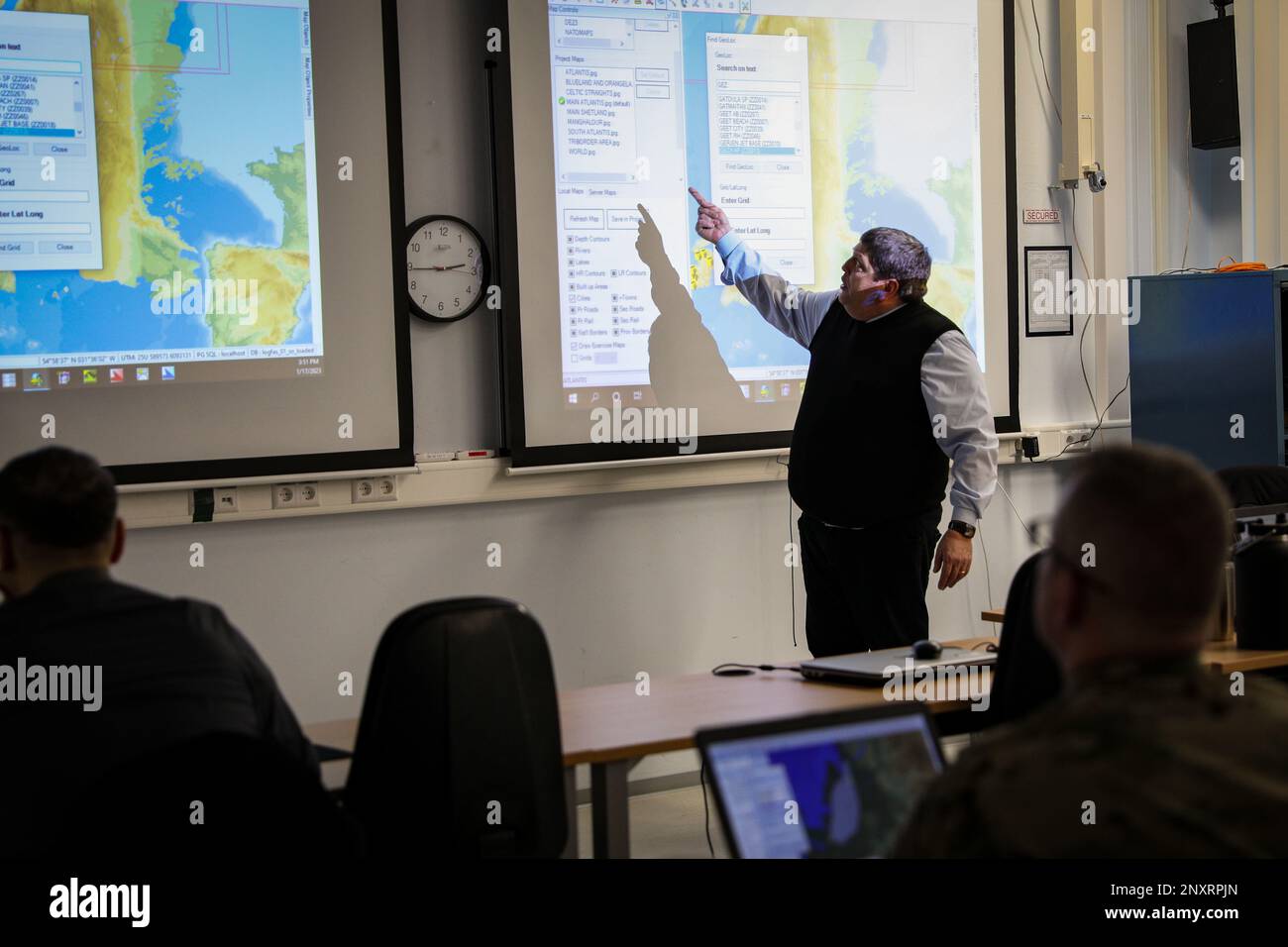 Mr. Alfonso Crencenzo, Logistics Functional Area Services (LOGFAS) subject matter expert, 21st Theater Sustainment Command, points at the screen to explain the capabilities within LOGFAS. LOGFAS is the NATO tool for logistics that integrates and manages logistics information. This in-depth instruction will proceed for two weeks in preparation for joint logistics operations, and joint training in the United Kingdom in March 2023. Stock Photo