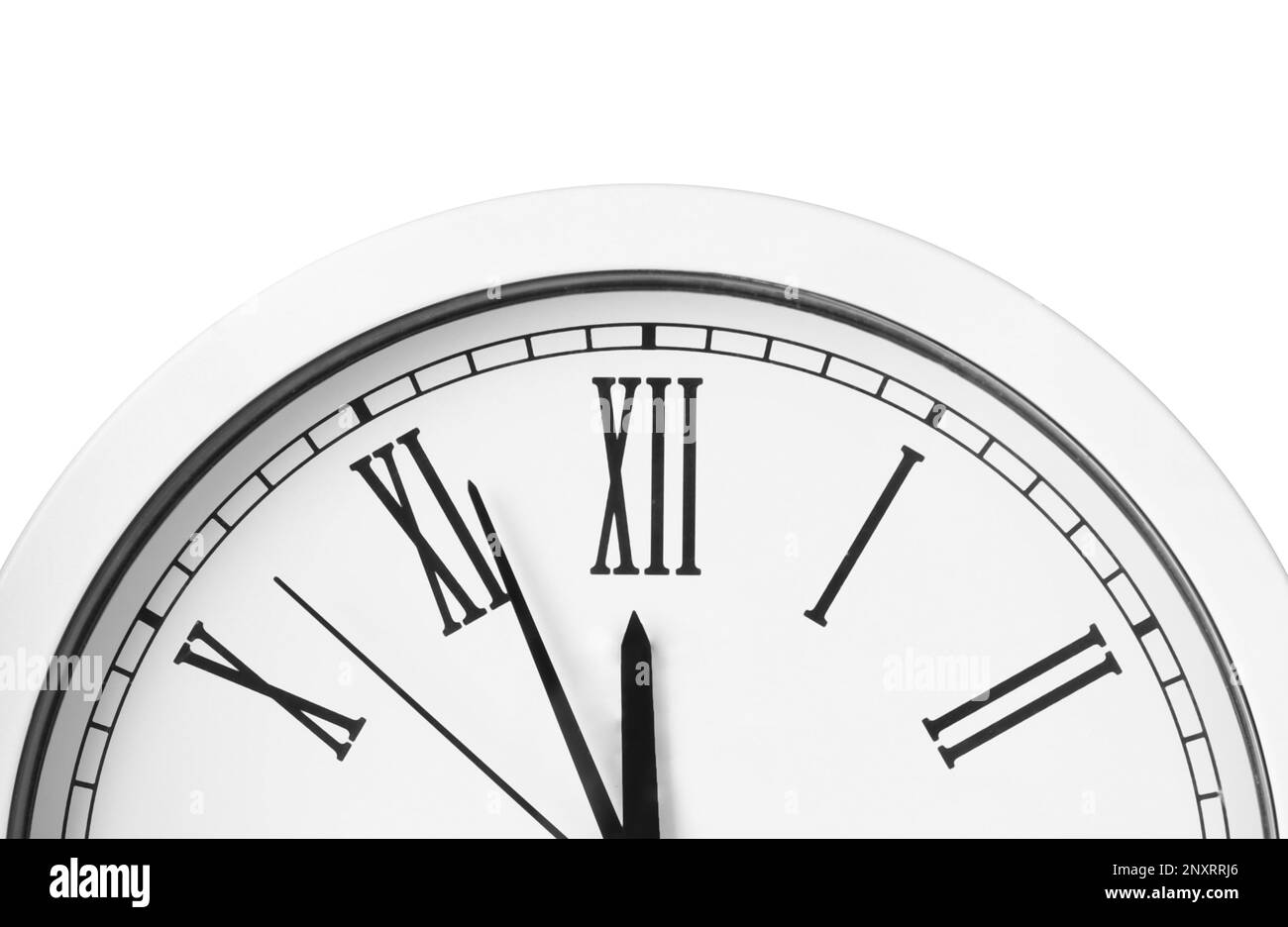 Clock showing five minutes until midnight on white background, closeup
