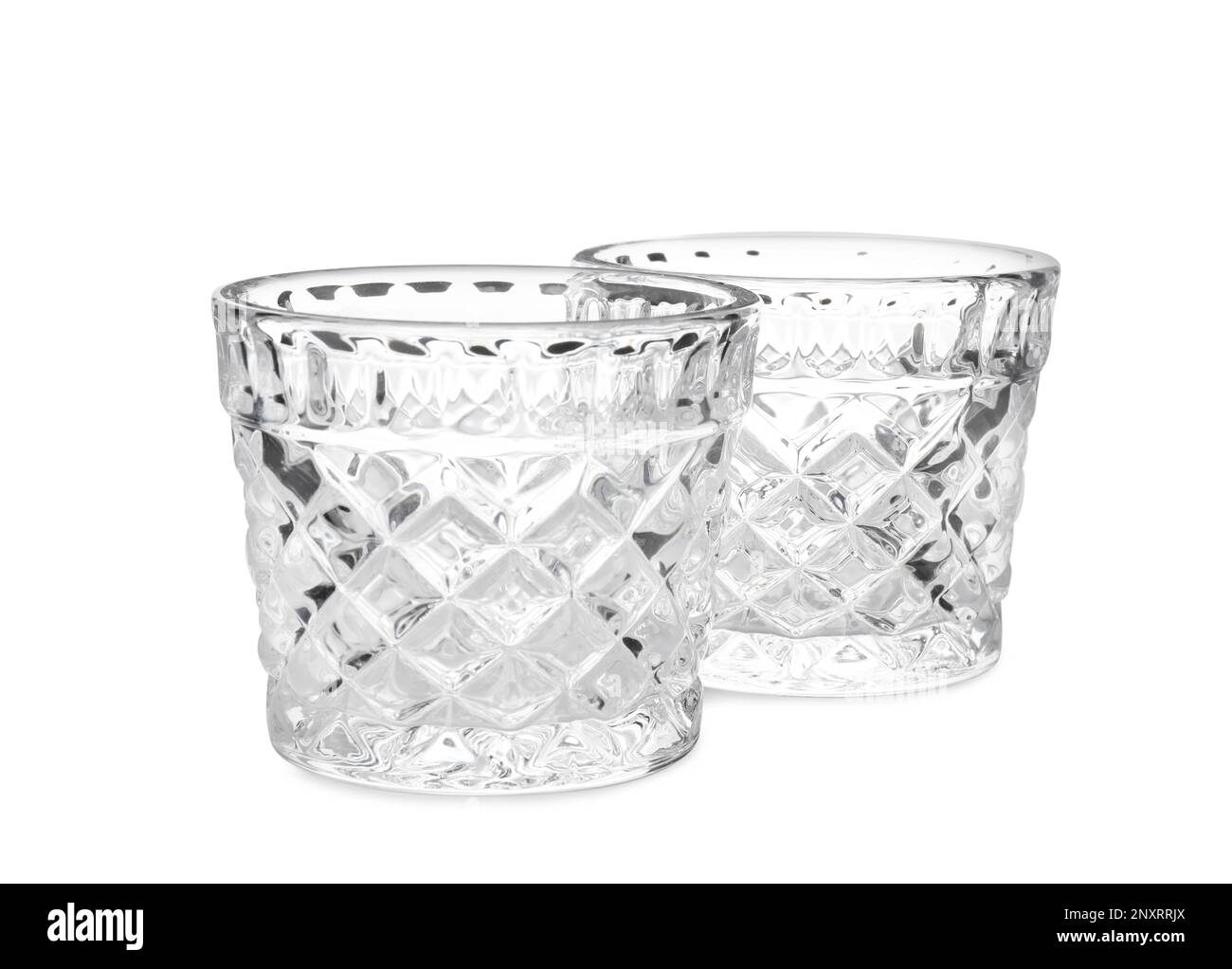 Two modern glass candle holders on white background Stock Photo - Alamy