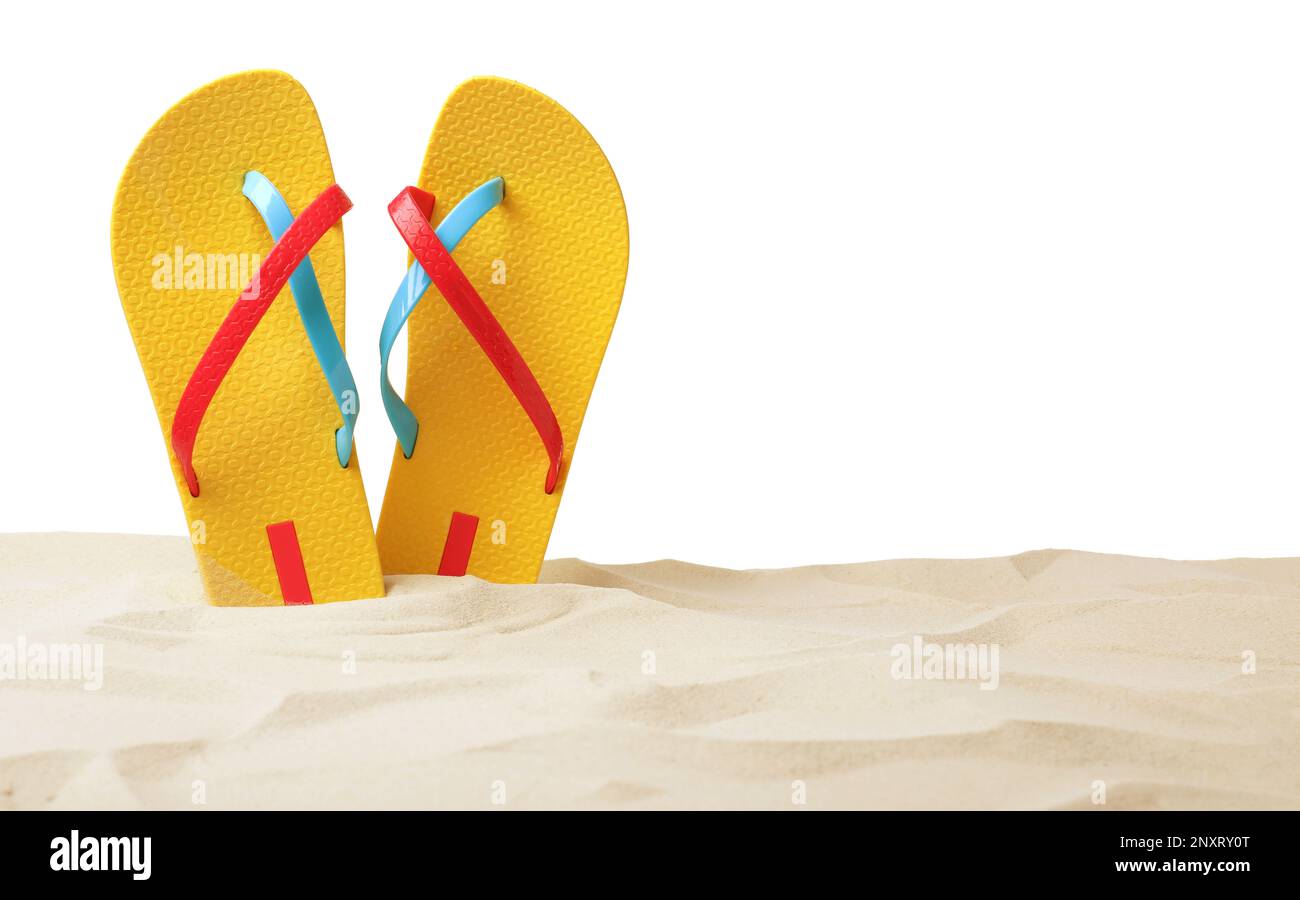 Yellow flip flops in sand on white background Stock Photo - Alamy