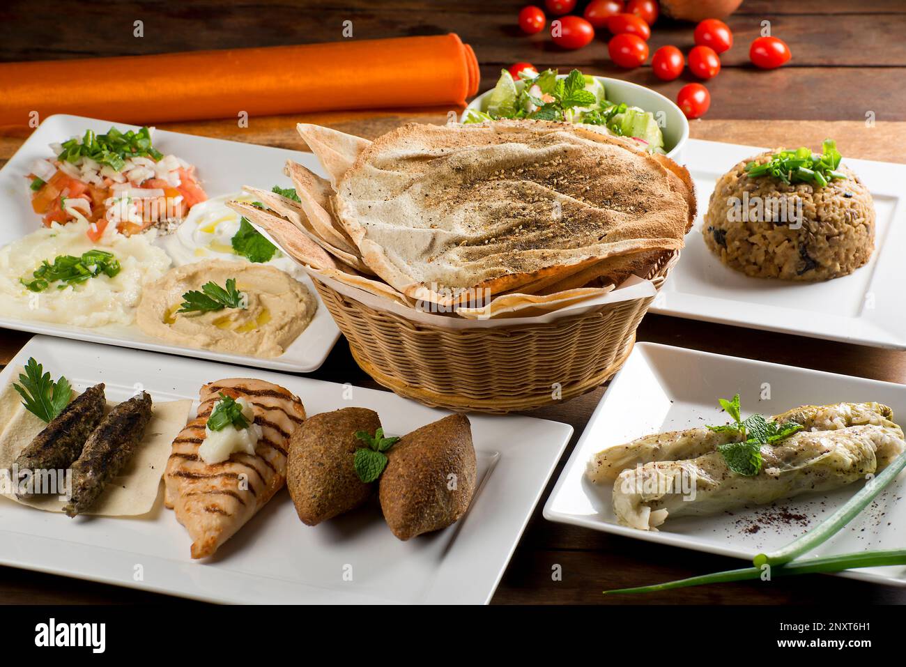arab banquet with hommos, labneh, chancliche, pita bread, fatouch, mjadra, charuto de arroz. meat,  chicken, kafta,  mediterranean Stock Photo