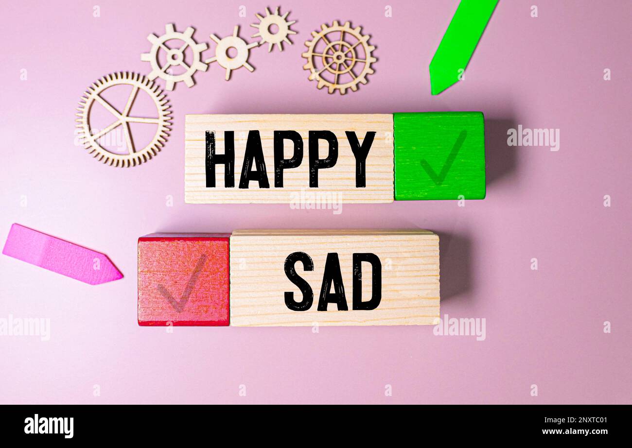 Happy Wooden blocks with HAPPY SAD text of concept Stock Photo