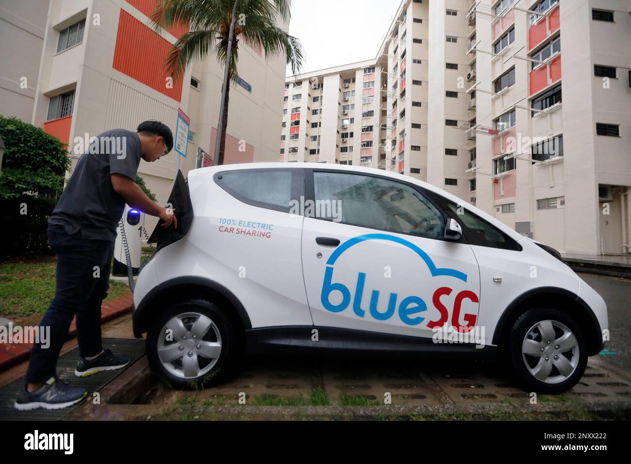 A user returning the electric vehicle he rented at a charging station in Yishun. Singapore's