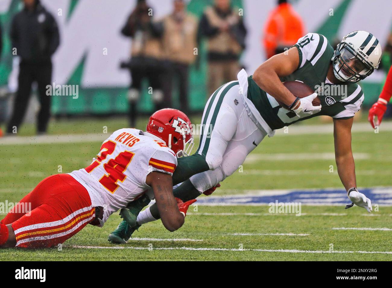 Kansas City Chiefs' Darrelle Revis, left, tackles New York Jets' Jermaine  Kearse during the first half of an NFL football game, Sunday, Dec. 3, 2017,  in East Rutherford, N.J. (AP Photo/Julie Jacobson