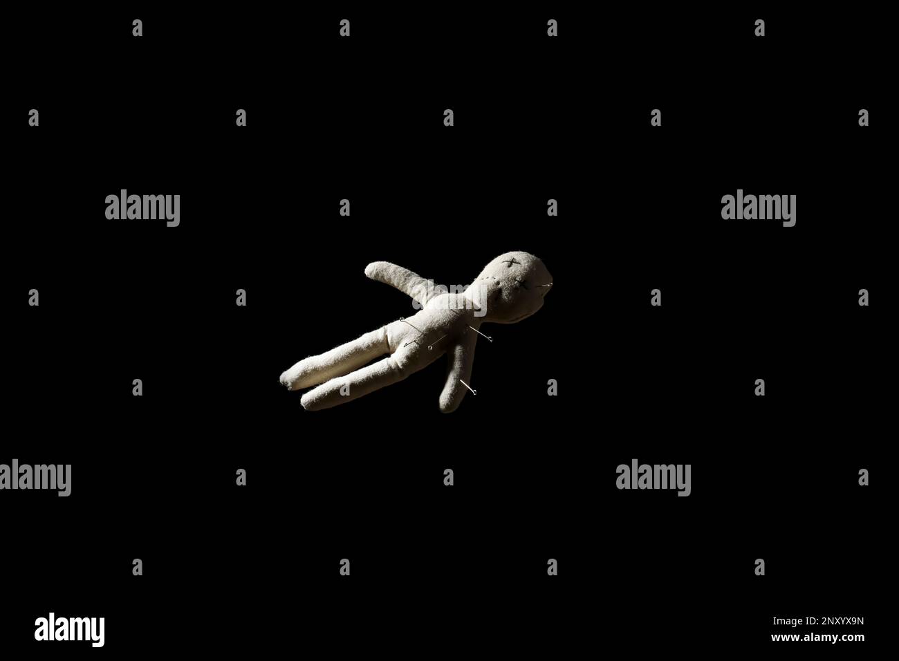 Voodoo doll with pins on black background Stock Photo - Alamy