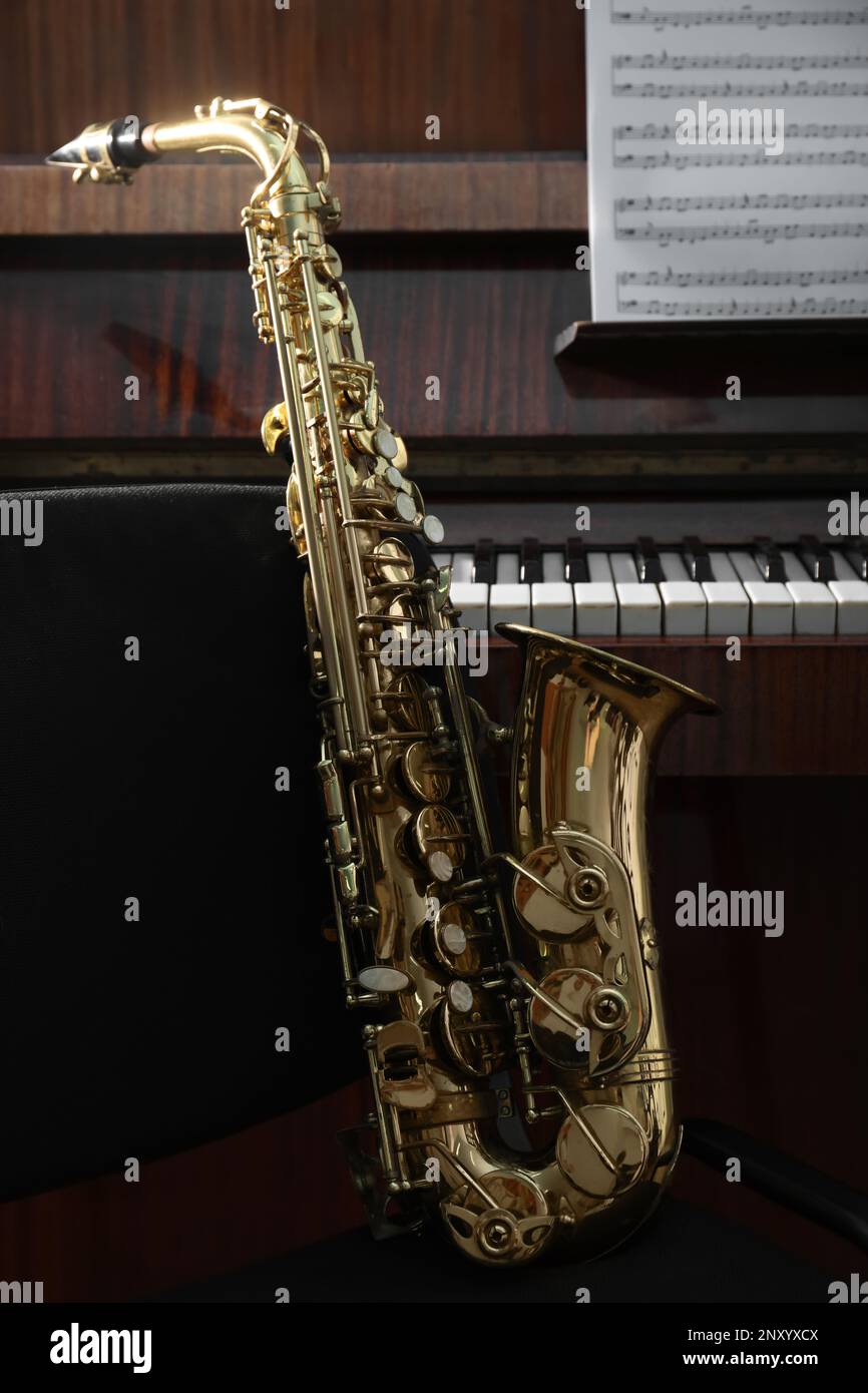 Beautiful saxophone near grand piano. Musical instruments Stock Photo