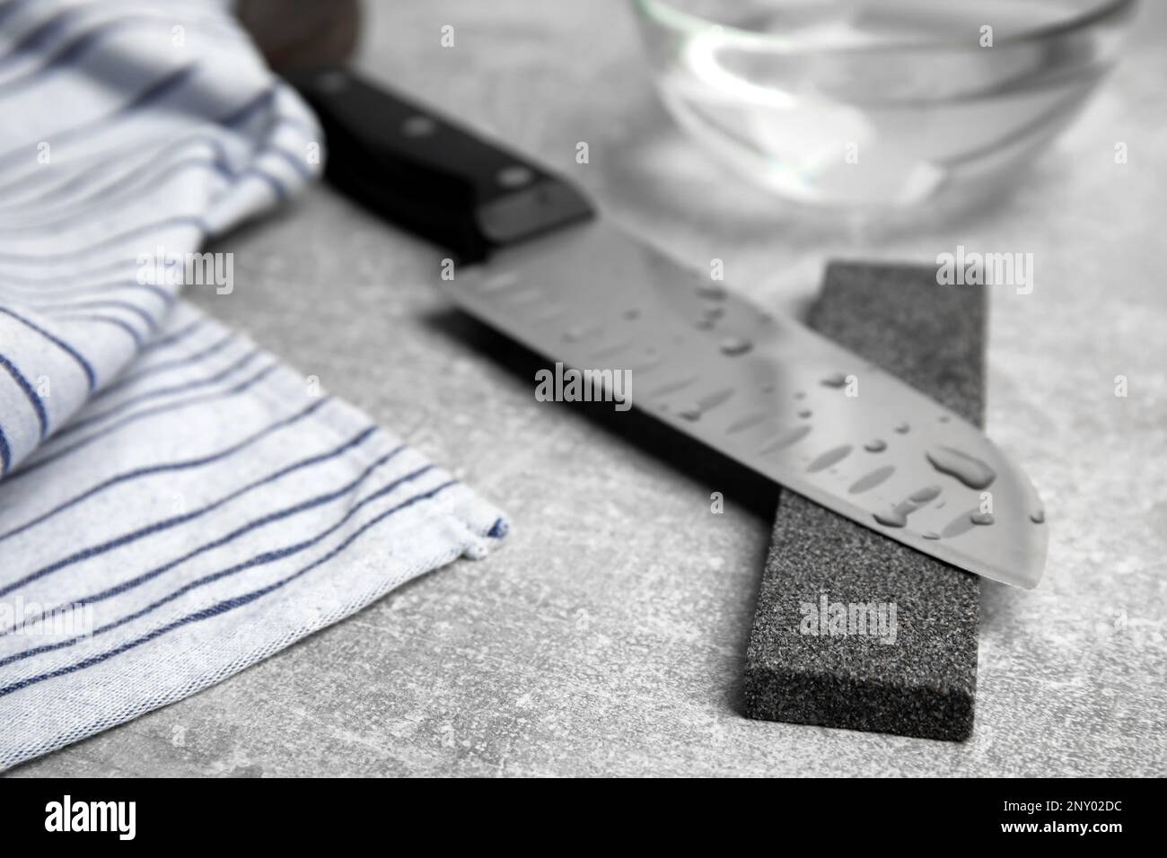 https://c8.alamy.com/comp/2NY02DC/sharpening-stone-and-knife-on-grey-table-closeup-2NY02DC.jpg