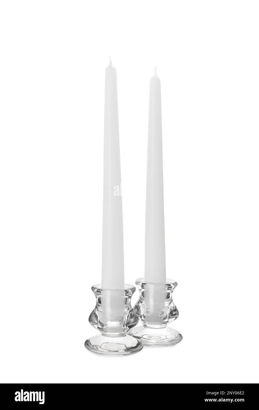 Elegant candlesticks with candles on white background Stock Photo Alamy