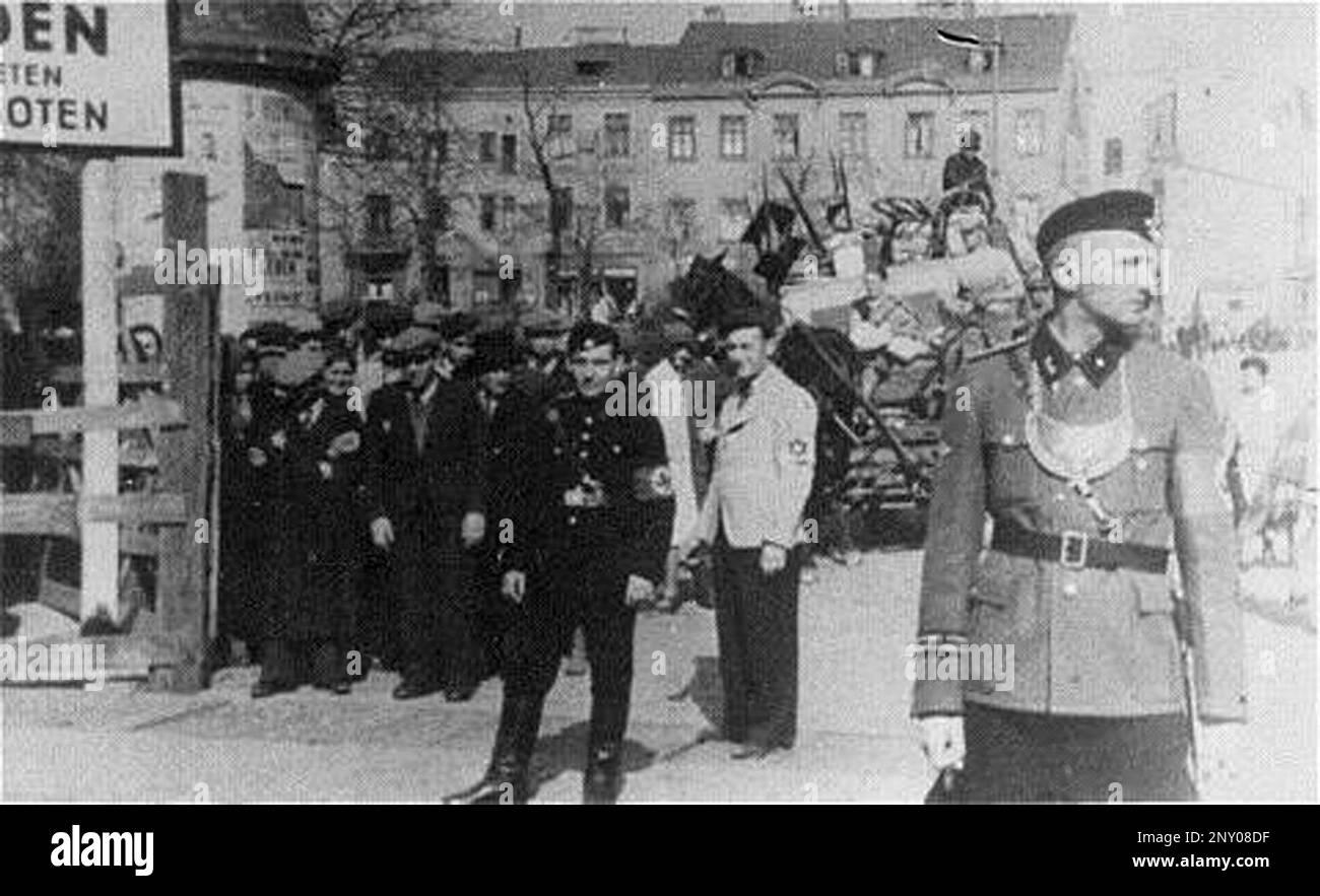 In the early stages of WW2 the Jews in nazi occupied europe were rounded up and forced into crowded ghettoes. When the decision was made to kill them all they were deported to extermination centres to be murdered. This image shows German and Jewish police guard at the entrance to the ghetto Stock Photo