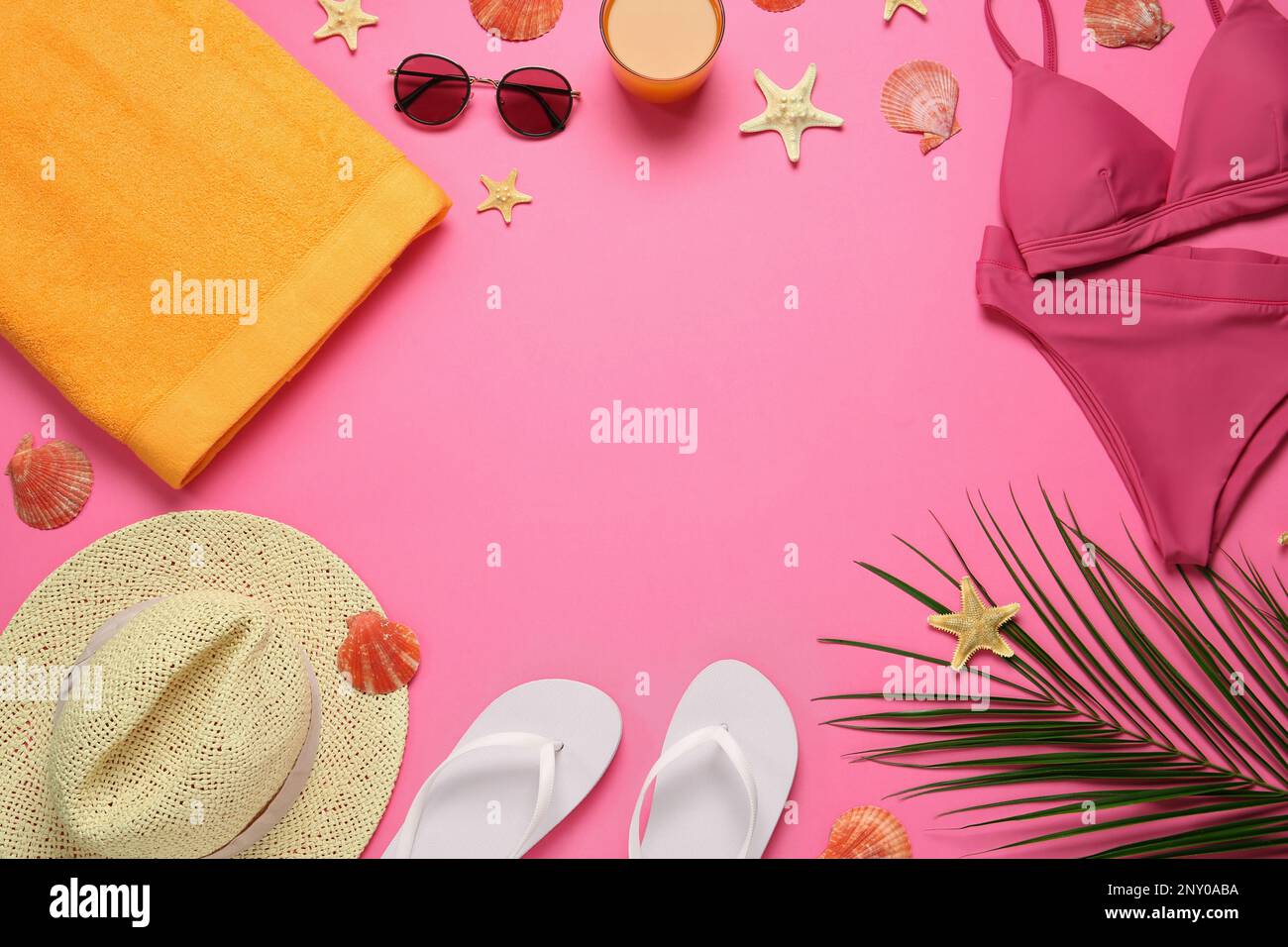 Frame made with different beach objects on pink background, flat lay. Space for text Stock Photo