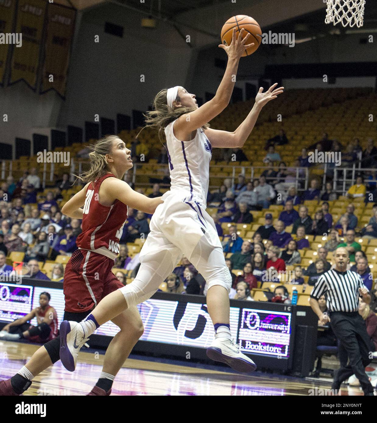St. Joseph's Sarah Veilleux, left, chases James Madison's Hailee Barron as  she jumps for the basket during the second quarter of an NCAA college  basketball game in Harrisonburg, Va., Sunday, Nov. 19,