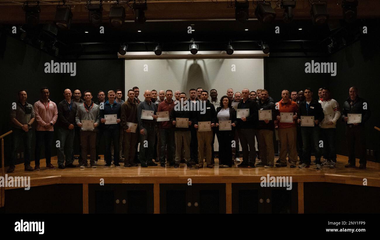 U.S. Marines and Sailors with III Marine Expeditionary Force pose for a group photo with their certificates of completion at the conclusion of the Scrum for Warfighters seminar, at Camp Kinser, Okinawa, Japan, Jan. 5, 2022. Scrum for Warfighters gives senior leaders an opportunity to share new ways to adapt and overcome to continuously changing environments and sharpen their problem-solving skills together. Stock Photo