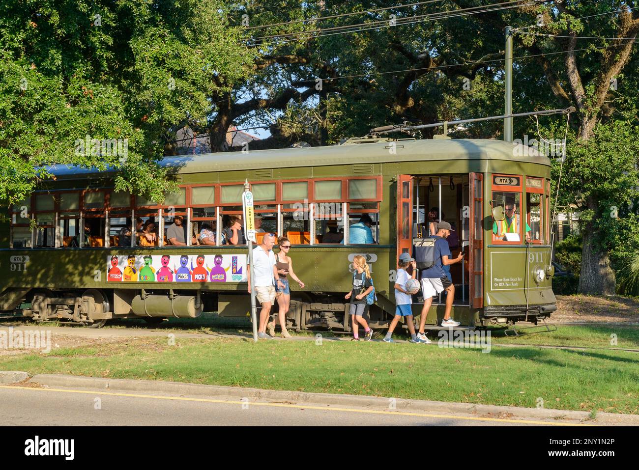 NEW ORLEANS, LA, USA - SEPTEMBER 19, 2023: Streetcar being boarded by family on North Carrollton Avenue Stock Photo