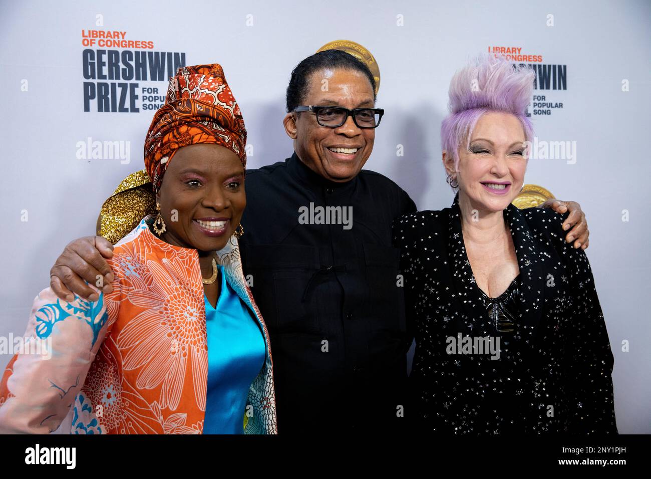 From left, Angelique Kidjo, Herbie Hancock and Cyndi Lauper pose for a