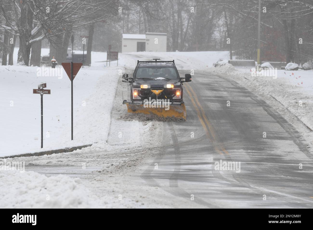 Brian Blassingame, 66th Civil Engineering Division supervisor, clears snow from a road at Hanscom Air Force Base, Mass., Feb. 23. A wintry mix of snow, sleet and freezing rain impacted the region. Stock Photo