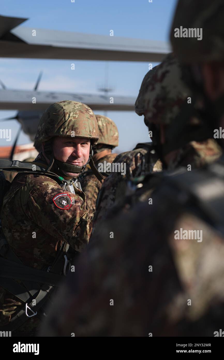 An Italian Army paratrooper with the Folgore Parachutist Brigade prepares to board a C-130 Hercules aircraft at Aviano Air Base, Italy, Jan. 26, 2023.    The 173rd Airborne Brigade is the U.S. Army's Contingency Response Force in Europe, providing rapidly deployable forces to the United States European, African, and Central Command areas of responsibility. Forward deployed across Italy and Germany, the brigade routinely trains alongside NATO allies and partners to build partnerships and strengthen the alliance. Stock Photo