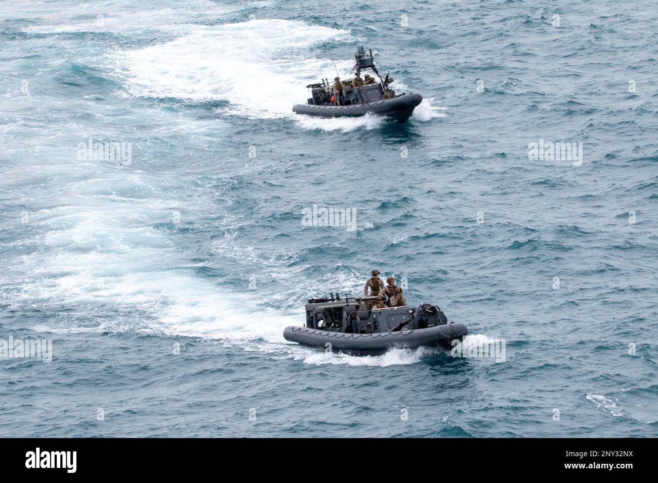 NATUNA SEA (Jan. 7, 2023) – Marines assigned to a Maritime Raid Force (MRF) platoon embarked aboard amphibious transport dock USS Anchorage (LPD 23) return from a Visit, Board, Search, and Seizure (VBSS) training exercise aboard Lewis B. Puller-class expeditionary mobile base USS Miguel Keith (ESB 5), Jan. 7. Synchronizing the complementary capabilities of the 13th Marine Expeditionary Unit (MEU) and USS Anchorage multiplies the traditional influence of sea power to produce a more competitive and lethal force. The Makin Island Amphibious Ready Group, comprised of amphibious assault ship USS Ma Stock Photo