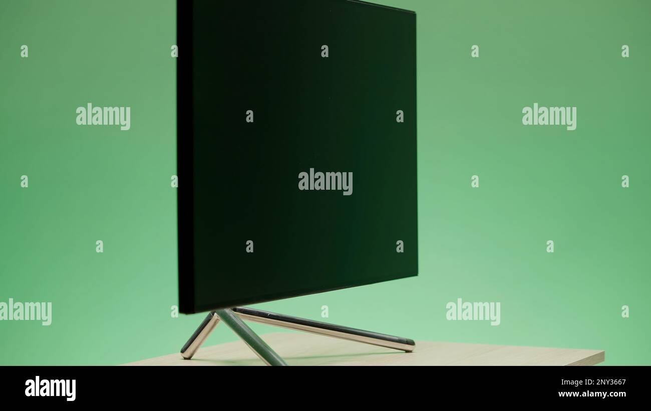 Large plasma TV. Action. A blue background with a changing color with a new generation TV that is shot from all angles. High quality 4k footage Stock Photo