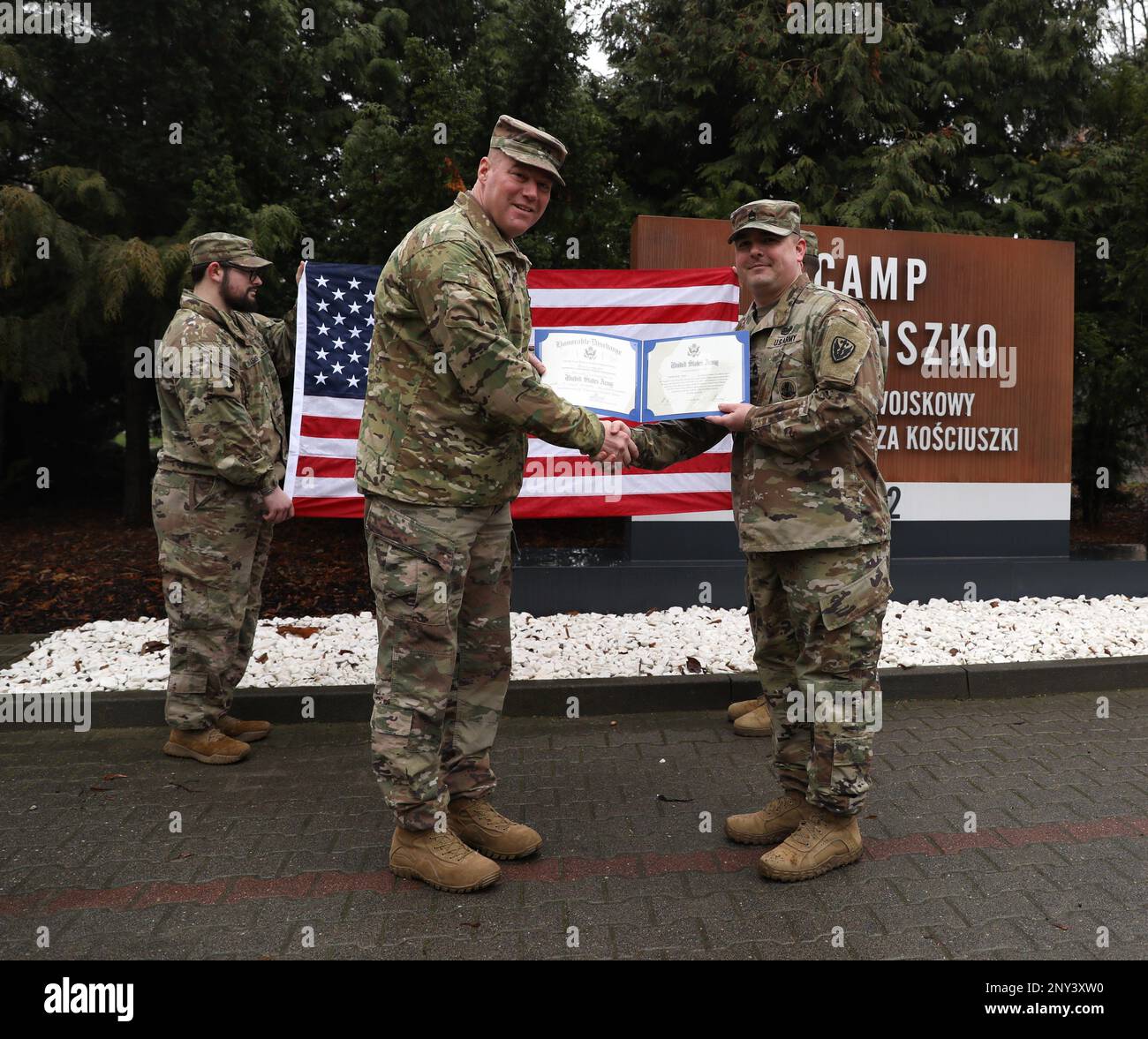 U.S. Army Maj. Gen. Christopher G. Beck, deputy commanding general of maneuver for the III Armored Corps, and Sgt. First Class Kenneth Lane, Alpha Company, 303rd Military Intelligence Battalion, 504th Military Intelligence Brigade, pose for a photo, during a reenlistment ceremony at Camp Kosciuszko, Poznan, Poland, Jan. 9, 2023. III Armored Corps is the world's premier mounted force, highly lethal, trained and ready to conduct sustained, expeditionary, operational maneuver anywhere in the world. Stock Photo