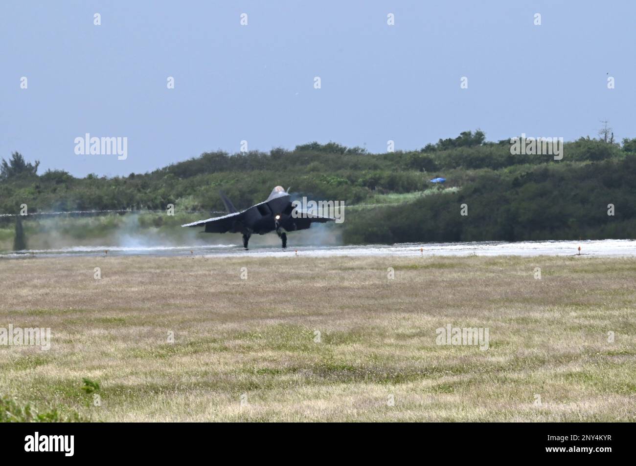 An F-22 Raptor assigned to the 525th Expeditionary Fighter Squadron, Kadena Air Base, Japan, lands during Exercise Agile Reaper 23-1 at Tinian International Airport, Northern Mariana Islands, March 1, 2023. During the exercise, C-17s and F-22 Raptors assigned to the 525th Expeditionary Fighter Squadron will conduct training operations in the Mariana Islands Range Training Complex. The MIRC is a geographic area containing a complex of military training ranges, and includes land, sea, and airspace on and around the islands of Guam, Rota, Tinian, Saipan, and Farallon de Medinilla, as well as open Stock Photo