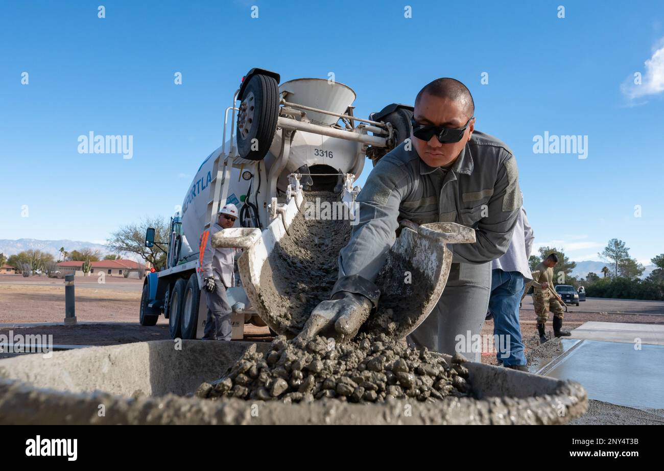 Airman 1st Class Samuel Babac, assigned to the 355th Civil Engineer Squadron, pushes concrete at Davis-Monthan Air Force Base, Ariz., Jan. 17, 2023. Babac took part in the project to create a drill pad for the DM honor guard team. Stock Photo