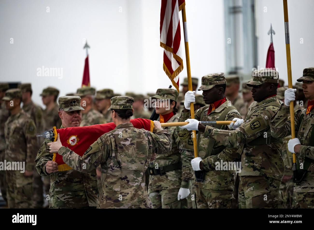 U.S. Army Lt. Col. Paul Mendoza, Commander of the 4th Battalion 3rd Air Defense Artillery Regiment (4-3 ADA), and U.S. Army Command Sgt. Maj. Brooke Martin, 4-3 ADA command sergeant major, case the 4-3 ADA flag during a transfer of authority on Jan. 26, 2023, Al Dhafra Air Base, United Arab Emirates. The 4-3 ADA transferred responsibility of the MIM-104 Patriot missile systems at Al Dhafra AB to the 2nd Battalion 43rd Air Defense Artillery Regiment before returning to garrison at Ft. Sill, Oklahoma. Stock Photo