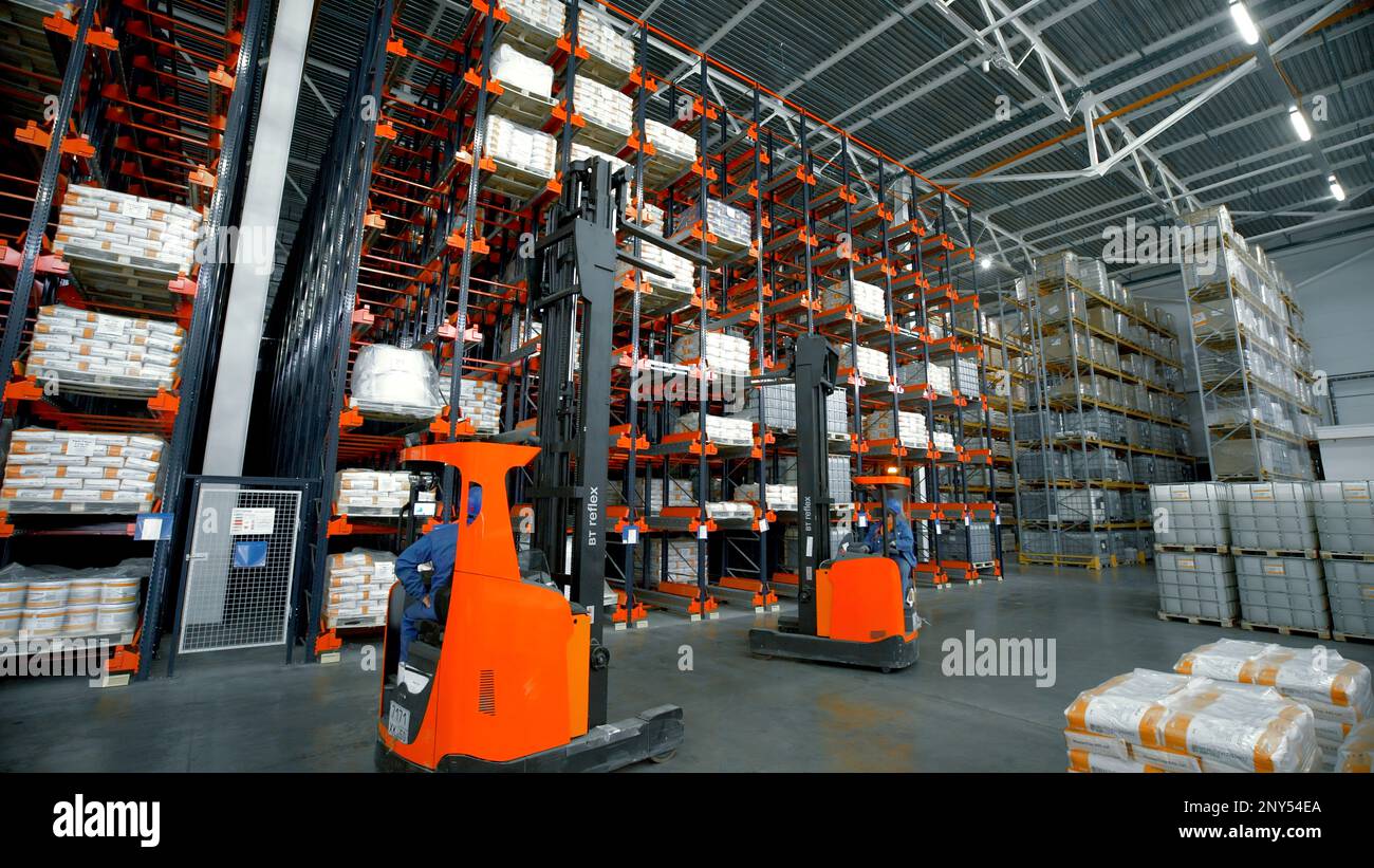 Madrid-Spain, October 8, 2022: Creative.A large bright warehouse with working equipment where the packed ordered goods are laid out. High quality 4k f Stock Photo
