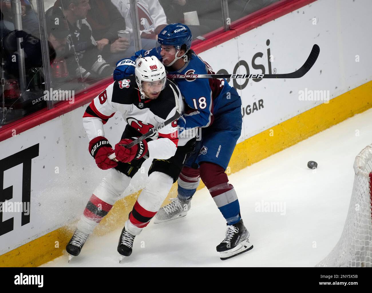 New Jersey Devils defenseman Kevin Bahl, left, gets tied up by Colorado