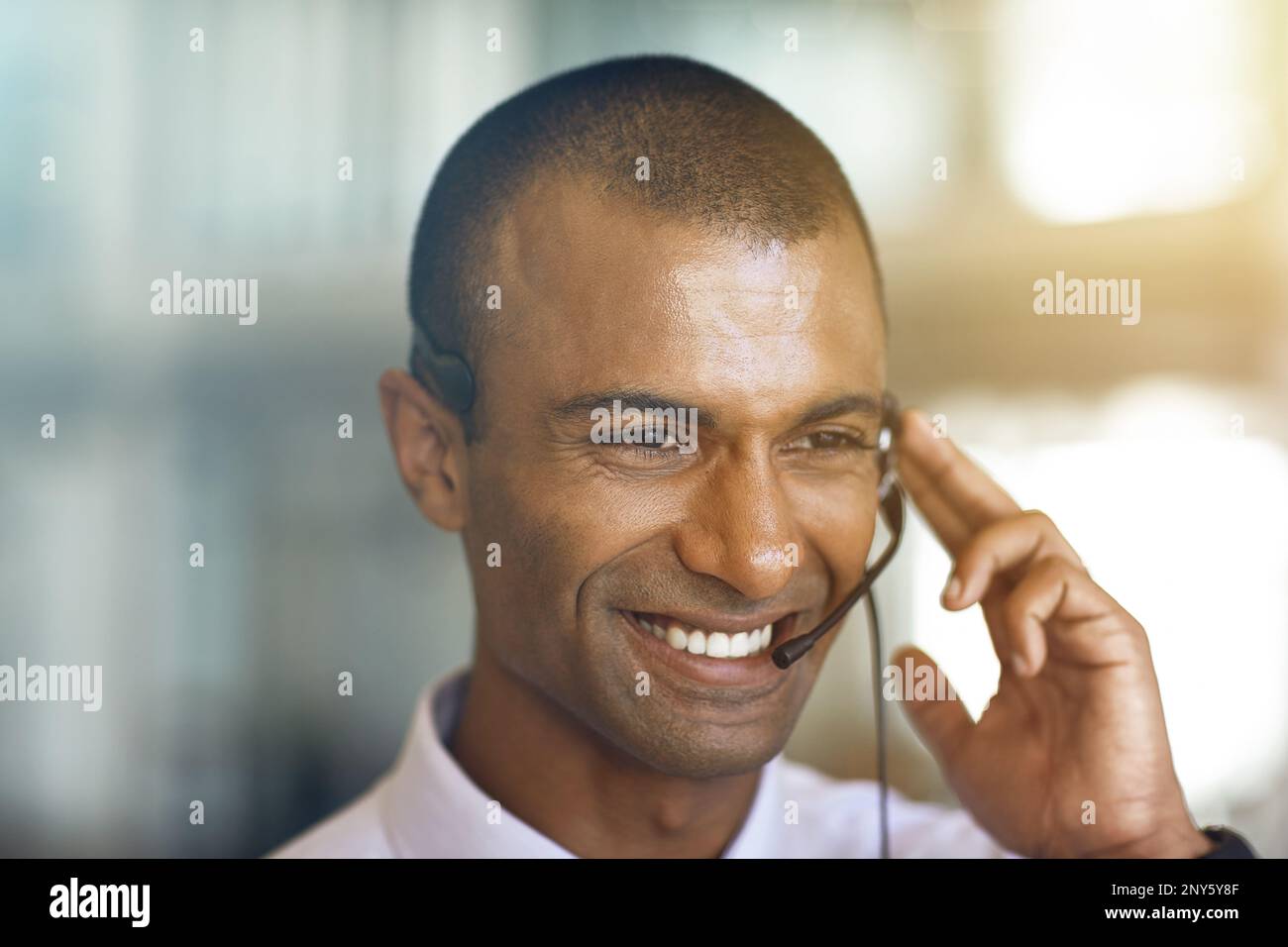Customer service at its best. a businessman communicating using his handsfree headset. Stock Photo