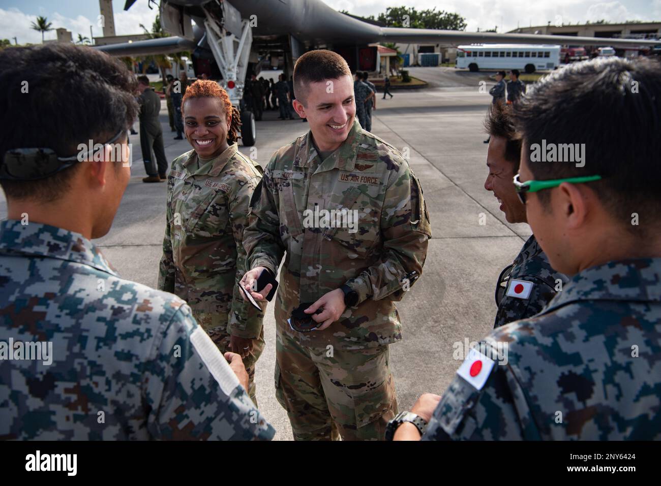 U.S. Air Force Airmen and Japan Air Self-Defense Force members trade patches during a static display in support of the Cope North 2023 exercise at Andersen Air Force Base, Guam, Feb. 8, 2023. CN23 objectives aim to further integrate the contributions of allies and partners to enhance security and stability to maintain a free and open Indo-Pacific region. Stock Photo